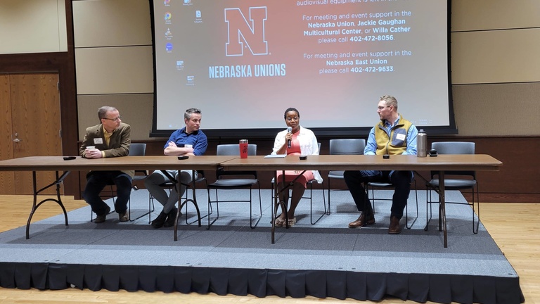 Four presenters at a table