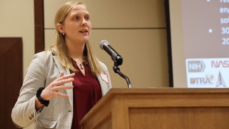 A person presenting at a conference
