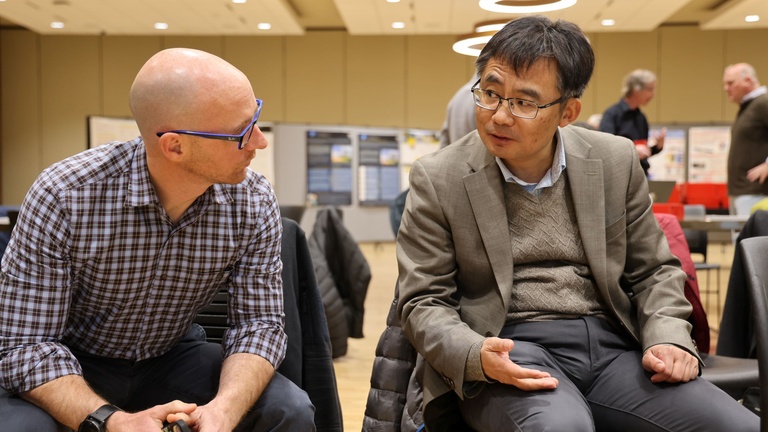 Two people talking at a conference