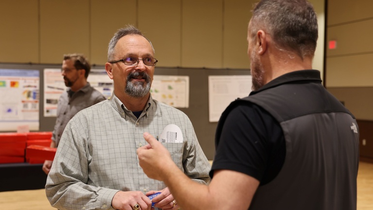 Two people talking at a conference
