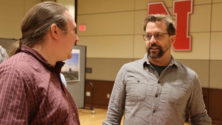 Two people talking at a conference