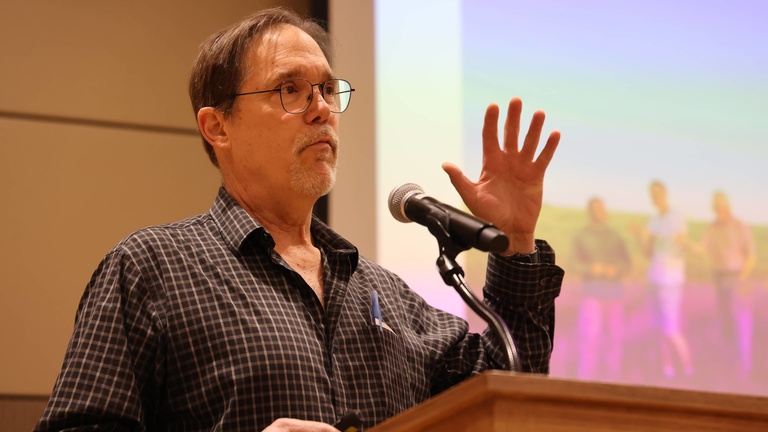 A person presenting at a conference